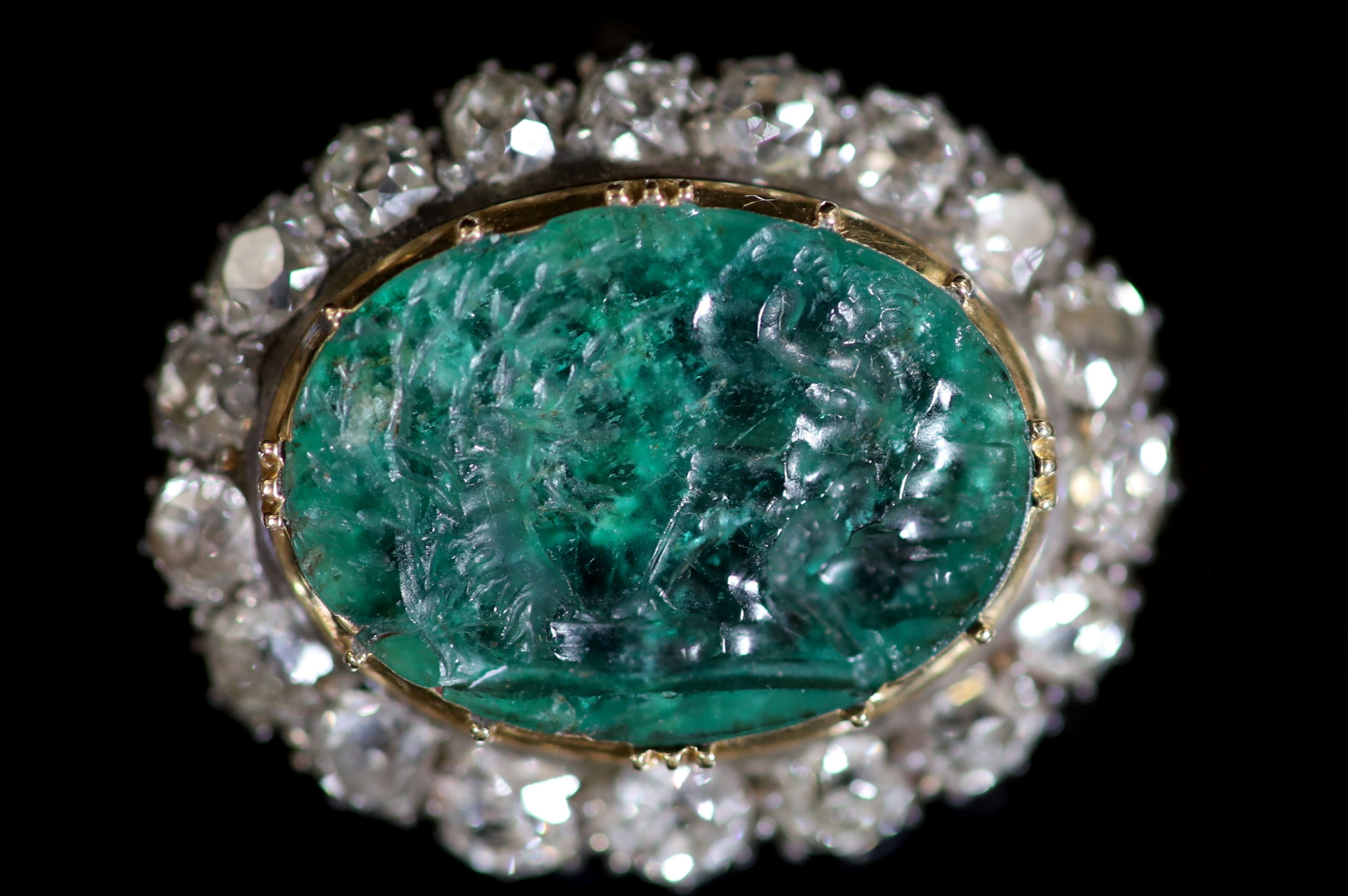 A possibly Roman oval intaglio emerald, mounted in an early Victorian gold, silver and diamond set oval pendant brooch